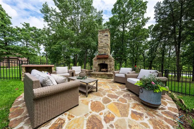 a view of a patio with couches and a table and chairs with garden view