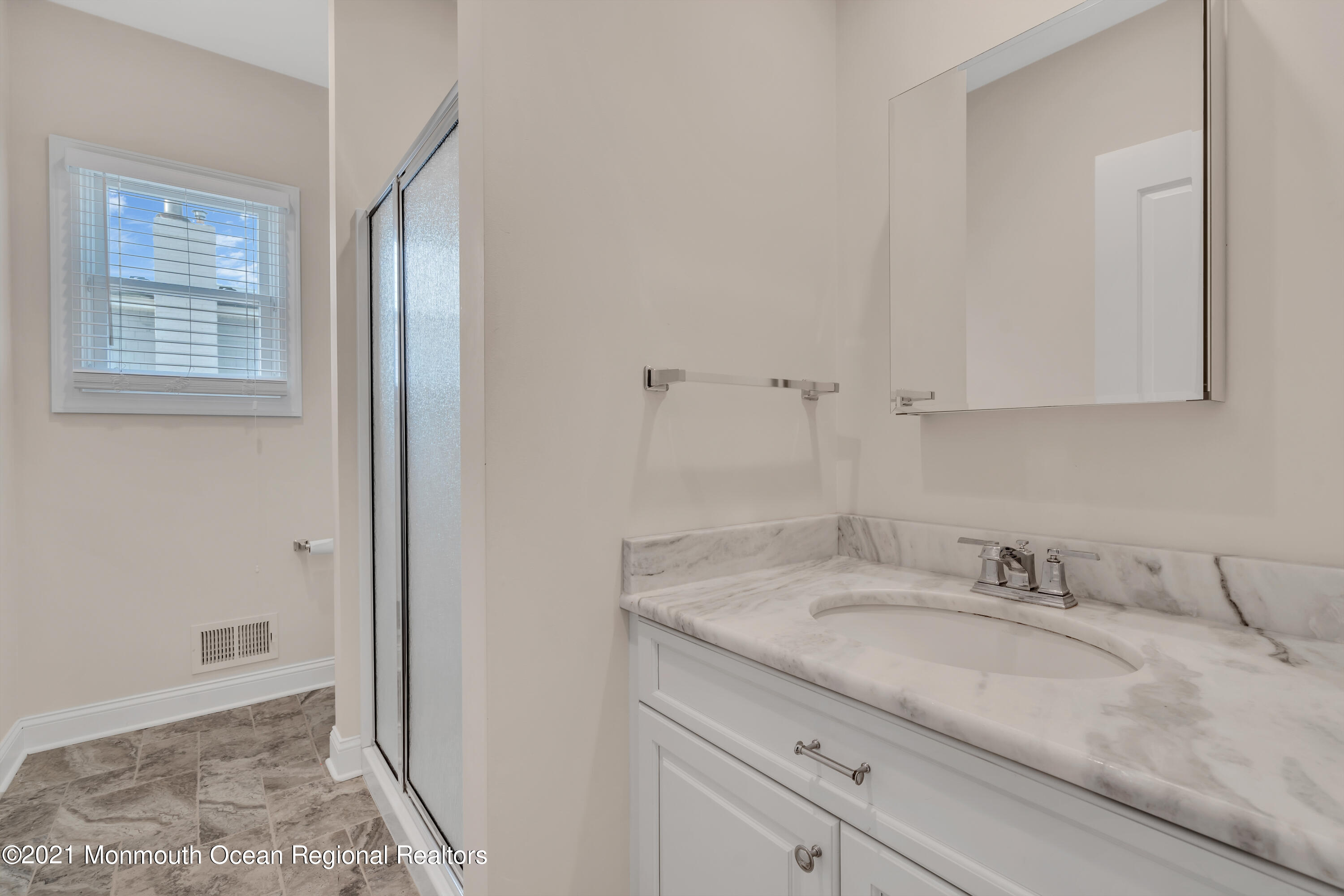 369 Beach Front Manasquan, NJ 08736 - Photo 18 of 49 a bathroom with a granite countertop sink and a mirror