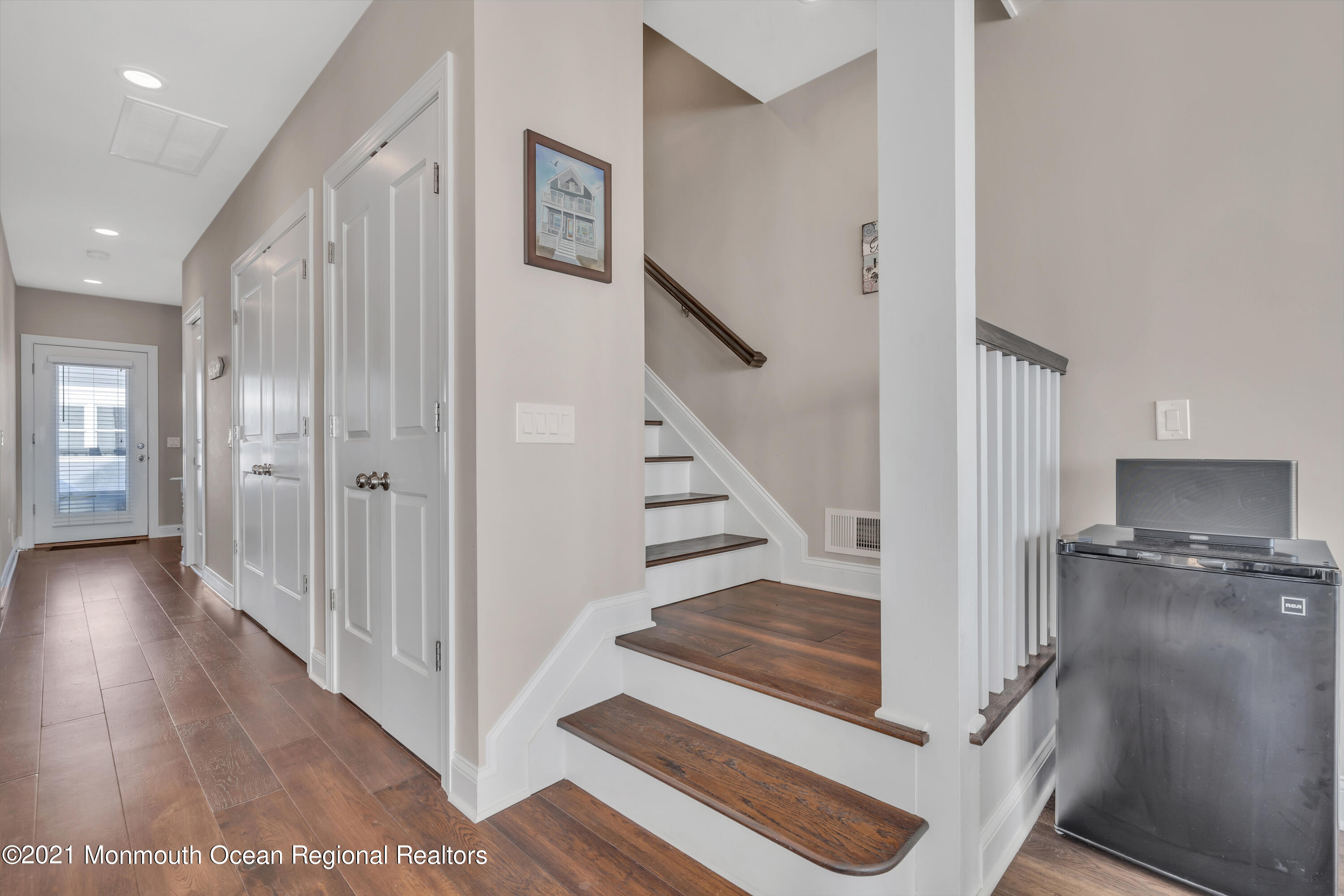 369 Beach Front Manasquan, NJ 08736 - Photo 20 of 49 a view of a hallway with wooden floor and staircase