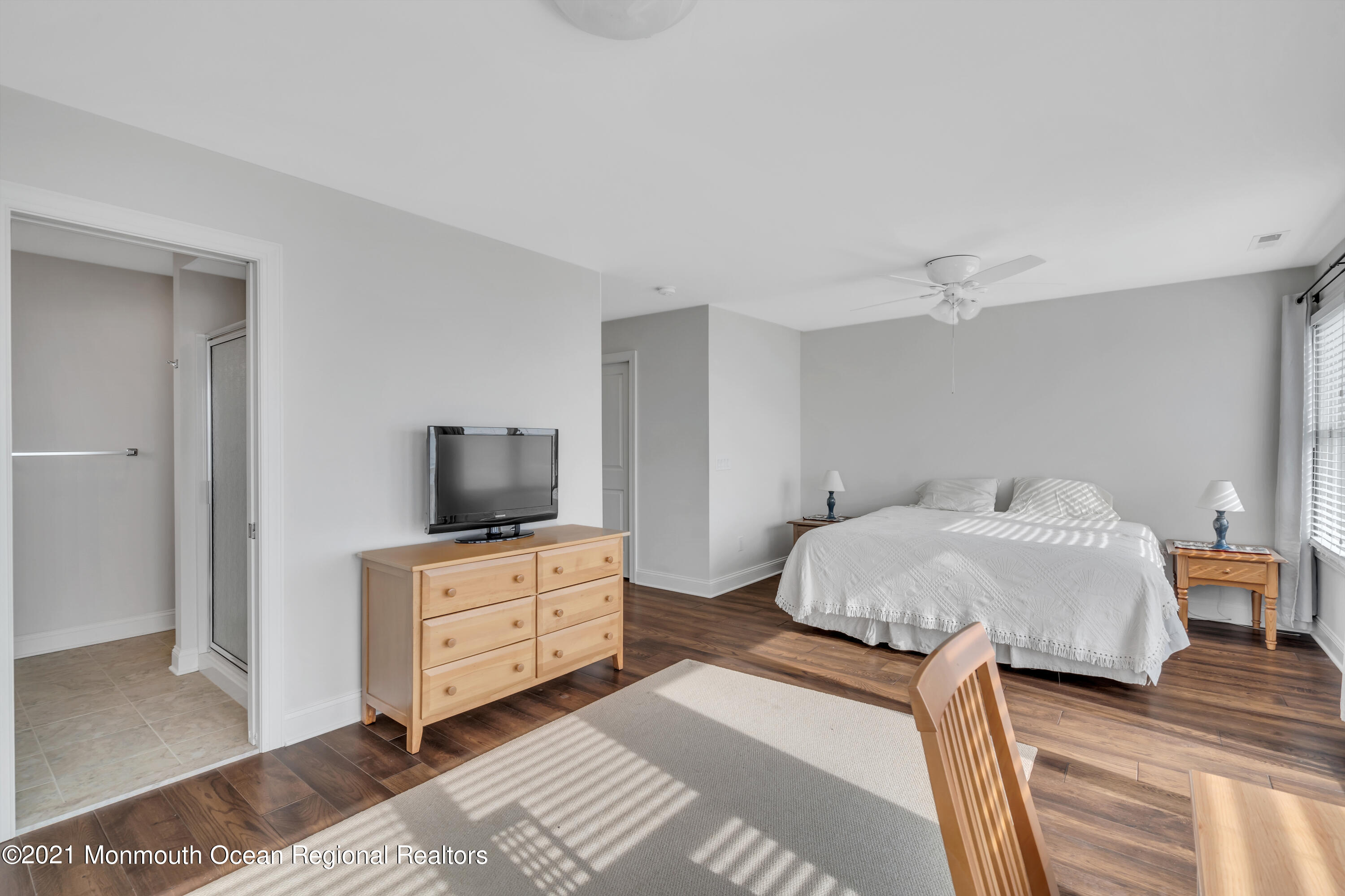 369 Beach Front Manasquan, NJ 08736 - Photo 21 of 49 a bedroom with a bed and wooden floor