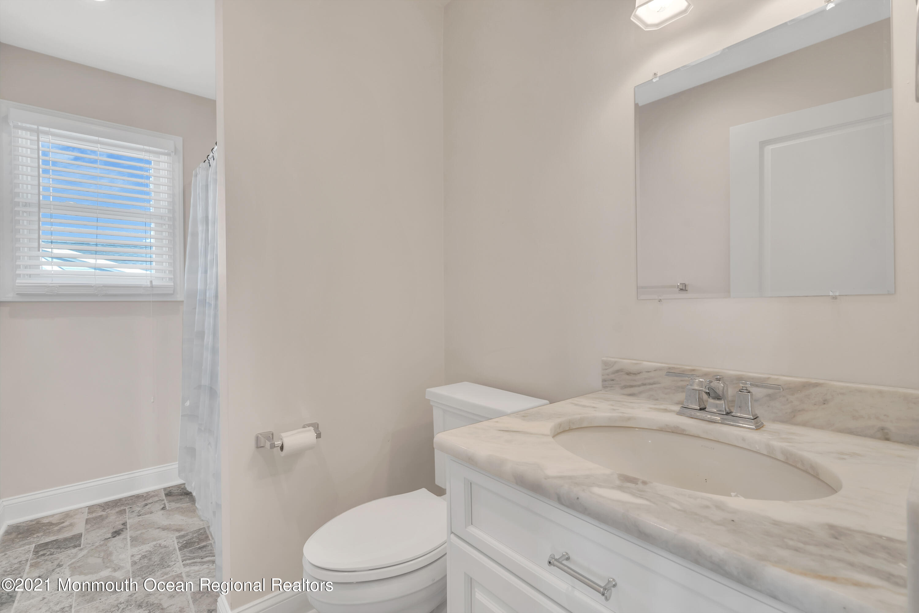 369 Beach Front Manasquan, NJ 08736 - Photo 30 of 49 a bathroom with a granite countertop toilet a sink and a mirror
