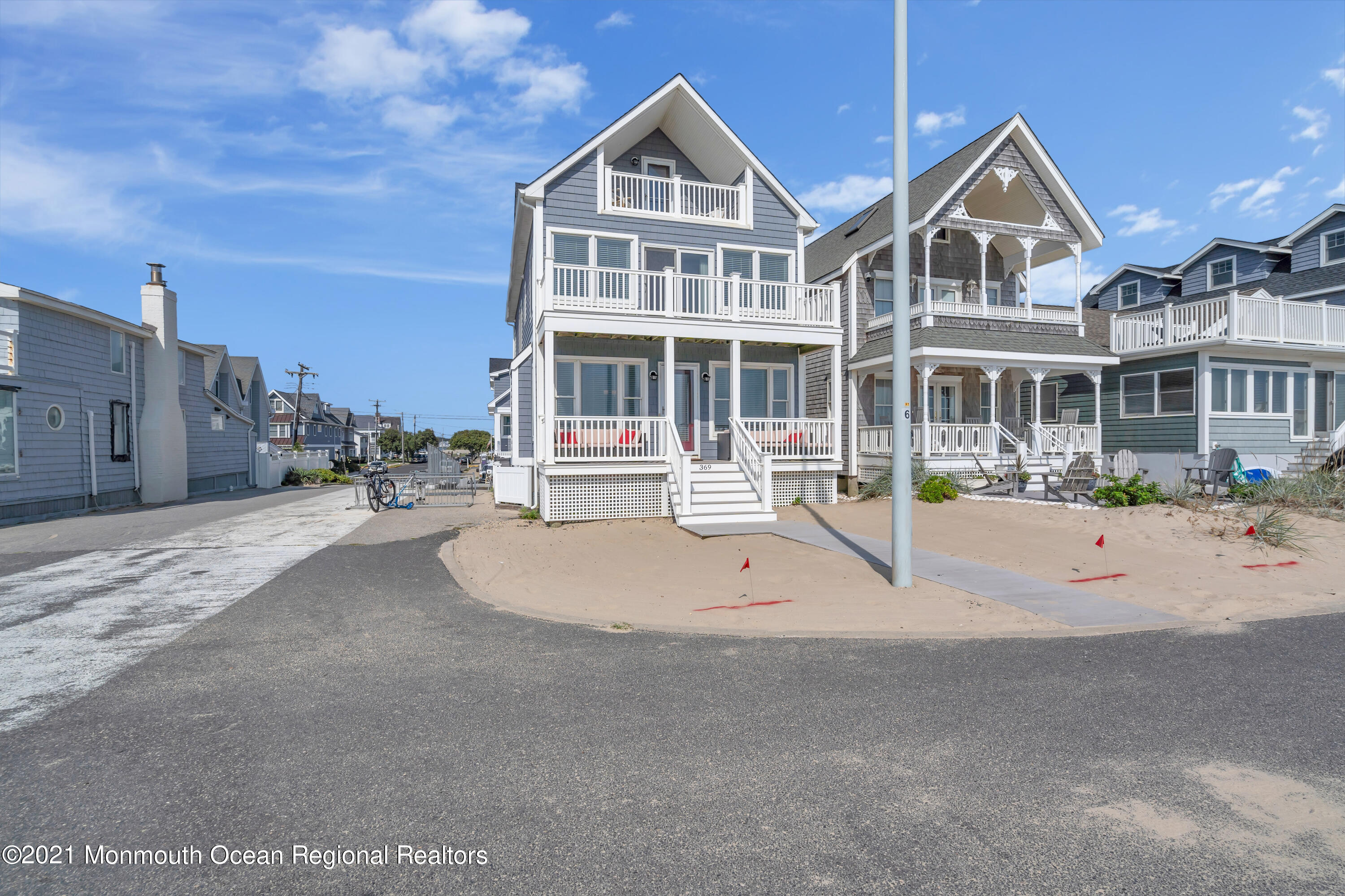 369 Beach Front Manasquan, NJ 08736 - Photo 42 of 49 a front view of a house with a yard and lake view