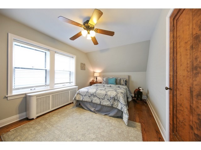 719 Arlington Road Riverside, IL 60546 - Photo 14 of 22 a bedroom with a bed and a chandelier