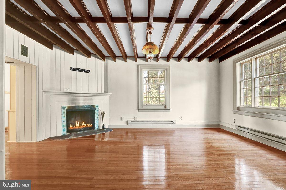 284 Old Mill Road Parkesburg, PA 19365 - Photo 19 of 50 a view of an empty room with exposed radiator and a fireplace