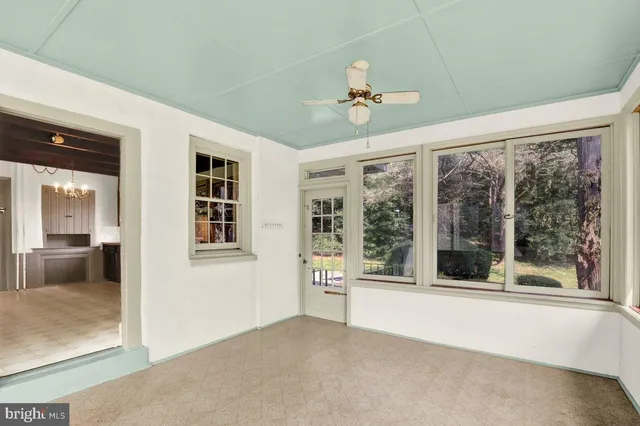 a view of a kitchen with wooden floor and a window
