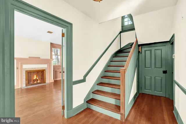 a view of entryway and hall with wooden floor