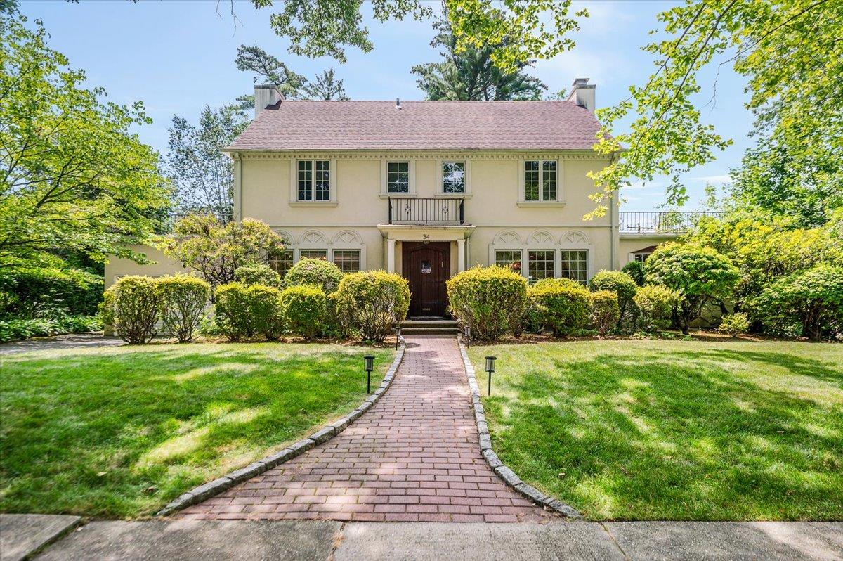 34 Arleigh Road Great Neck, NY 11021 - Photo 1 of 1 a front view of a house with a garden