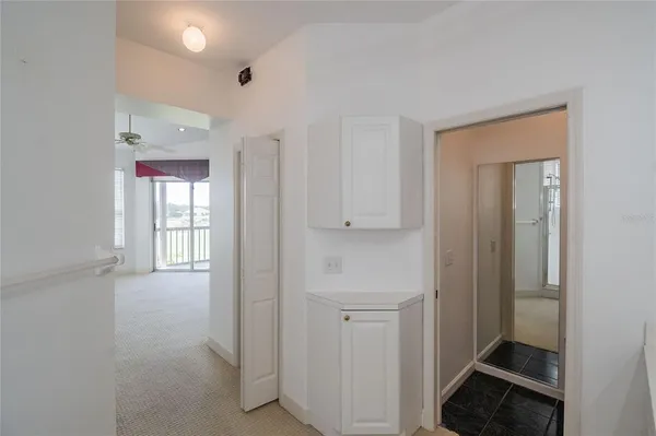 a view of hallway with bathroom
