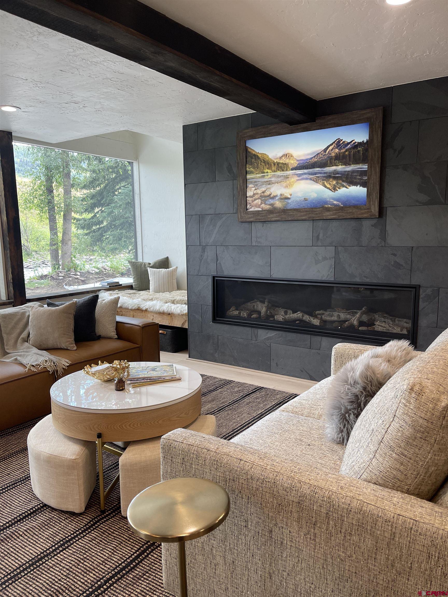 170 Lower Allen Road Crested Butte, CO 81224 - Photo 6 of 42 a living room with furniture and a fireplace