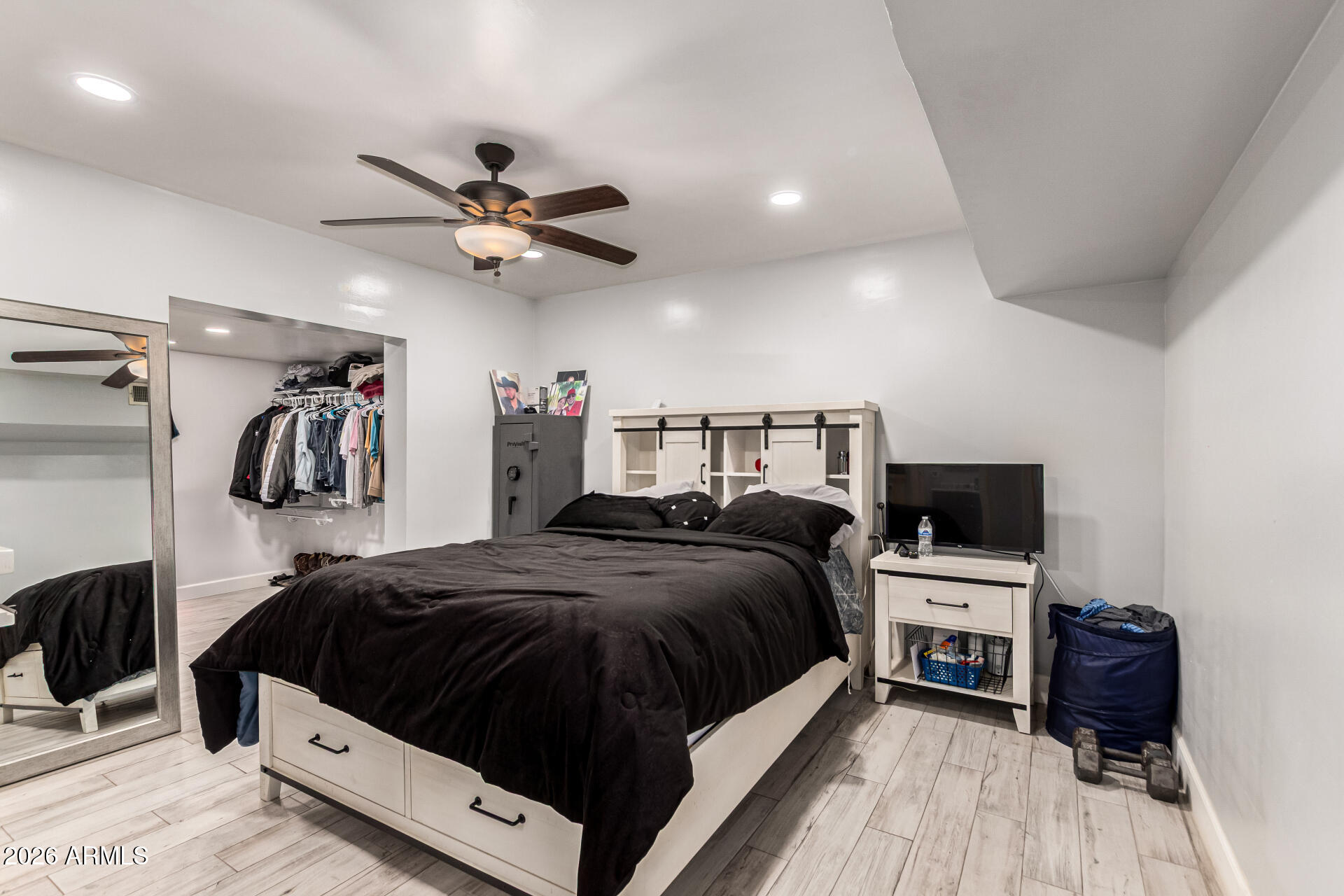 8218 West Osborn Road Phoenix, AZ 85033 - Photo 12 of 27 a bedroom with a bed and a chandelier