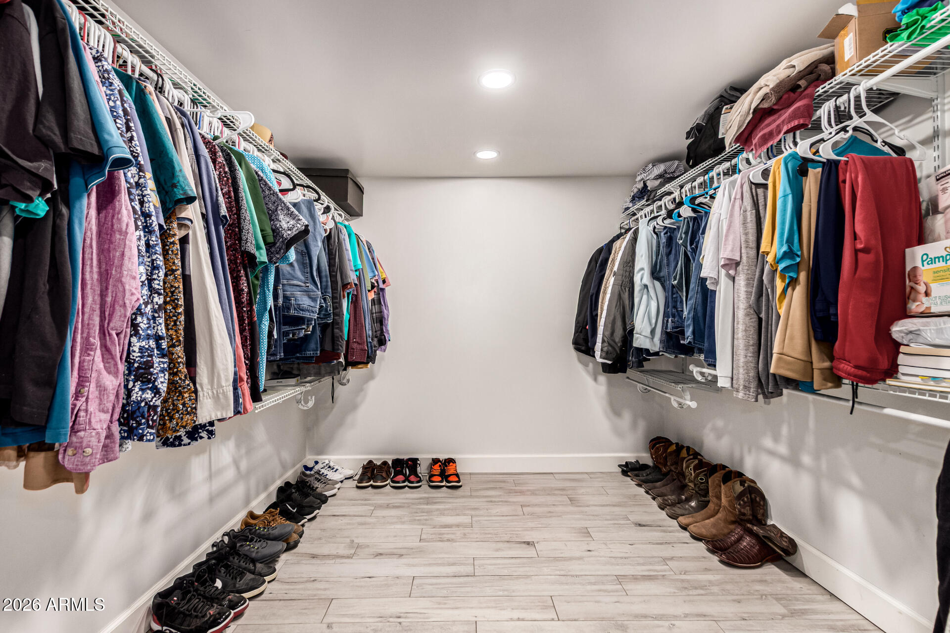 8218 West Osborn Road Phoenix, AZ 85033 - Photo 13 of 27 a view of walk in closet with clothes and shoes