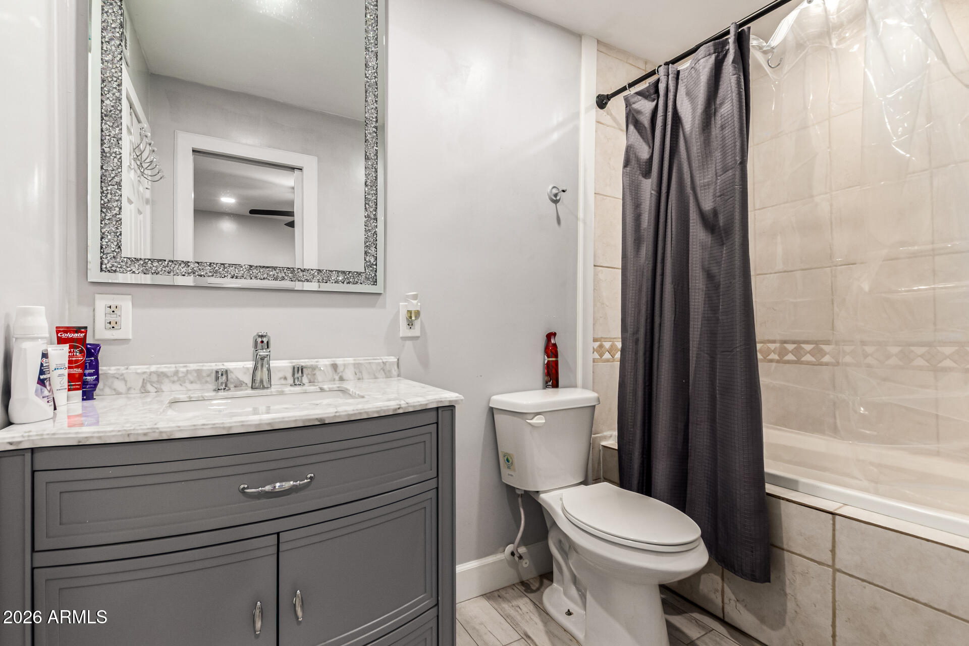 8218 West Osborn Road Phoenix, AZ 85033 - Photo 14 of 27 a bathroom with a granite countertop toilet sink and mirror