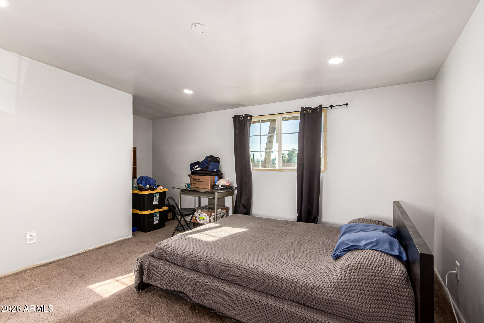 8218 West Osborn Road Phoenix, AZ 85033 - Photo 18 of 27 a bedroom with a bed and a window