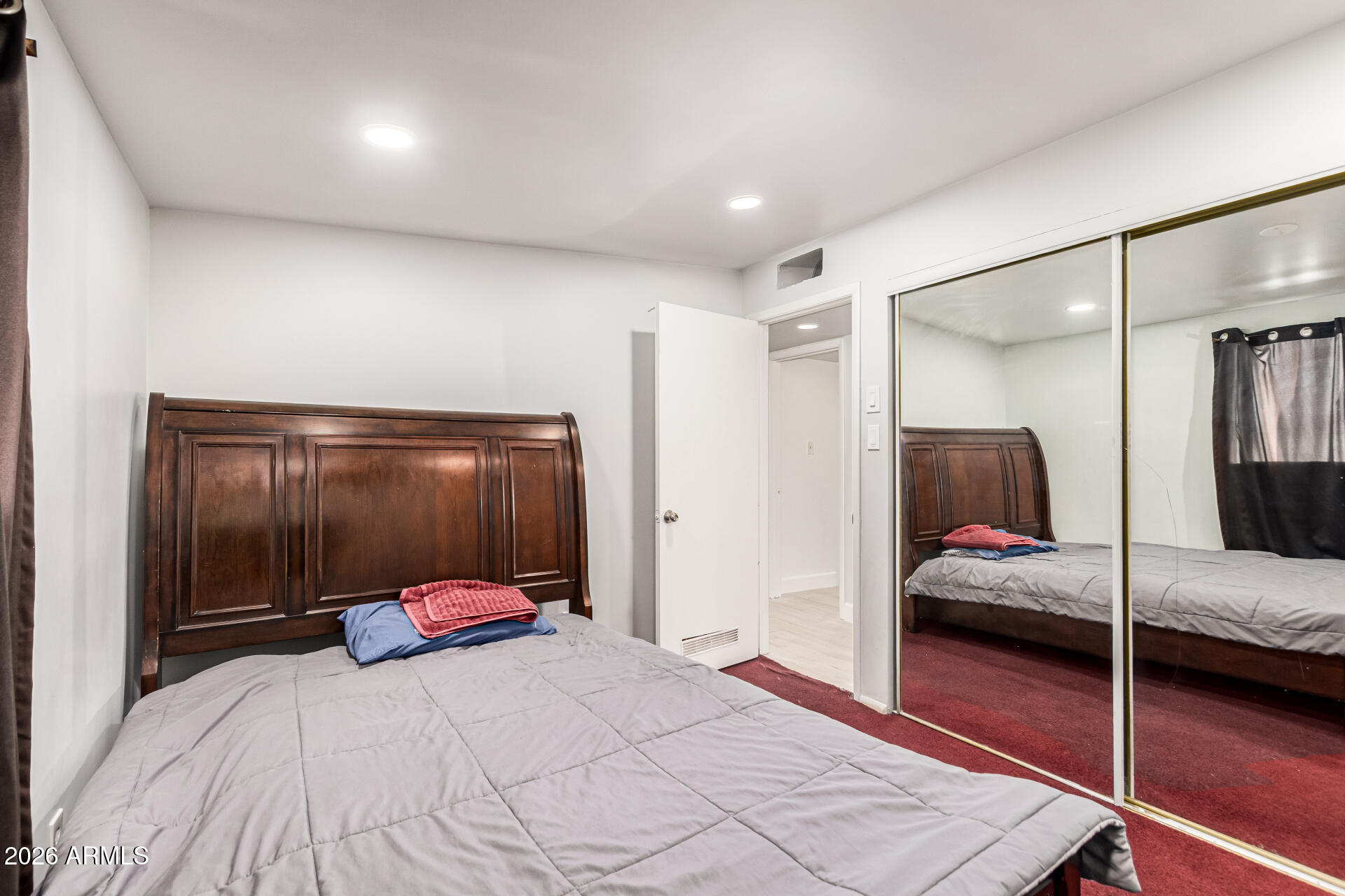 8218 West Osborn Road Phoenix, AZ 85033 - Photo 19 of 27 a bedroom with a bed and a mirror