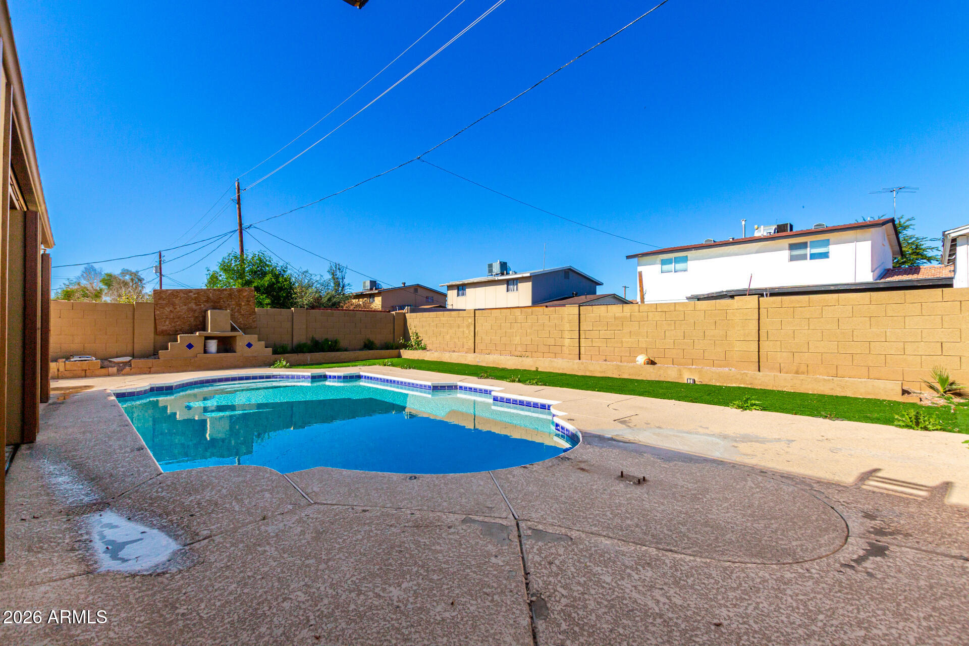 8218 West Osborn Road Phoenix, AZ 85033 - Photo 23 of 27 a swimming pool with outdoor seating and yard