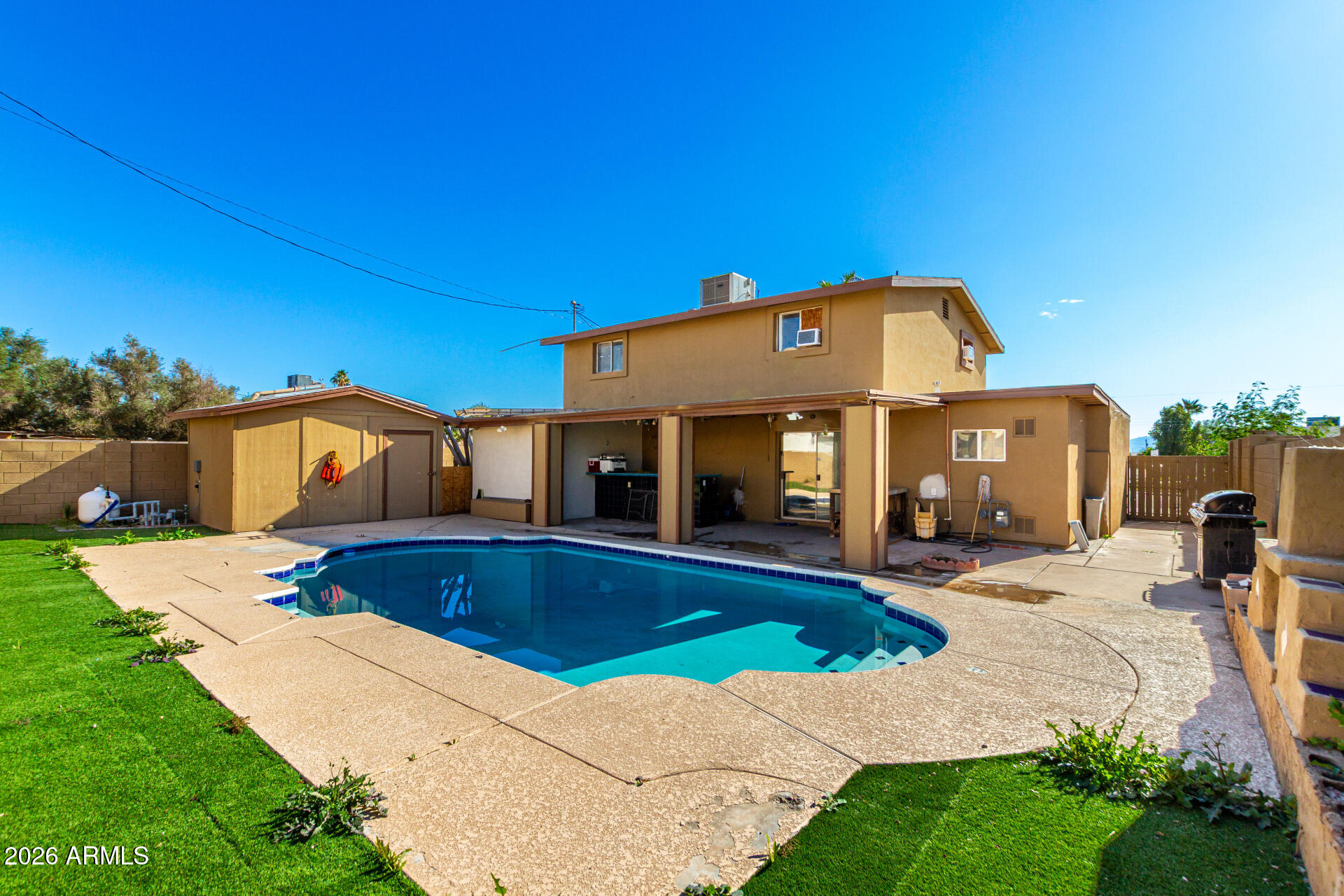 8218 West Osborn Road Phoenix, AZ 85033 - Photo 25 of 27 a view of a house with swimming pool and sitting area