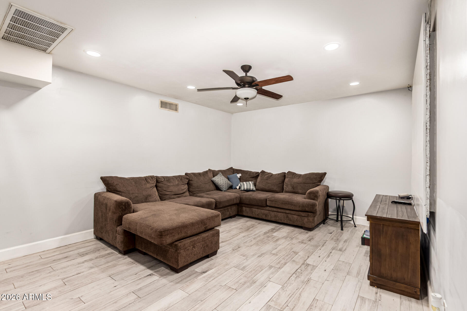 8218 West Osborn Road Phoenix, AZ 85033 - Photo 3 of 27 a living room with furniture and a wooden floor