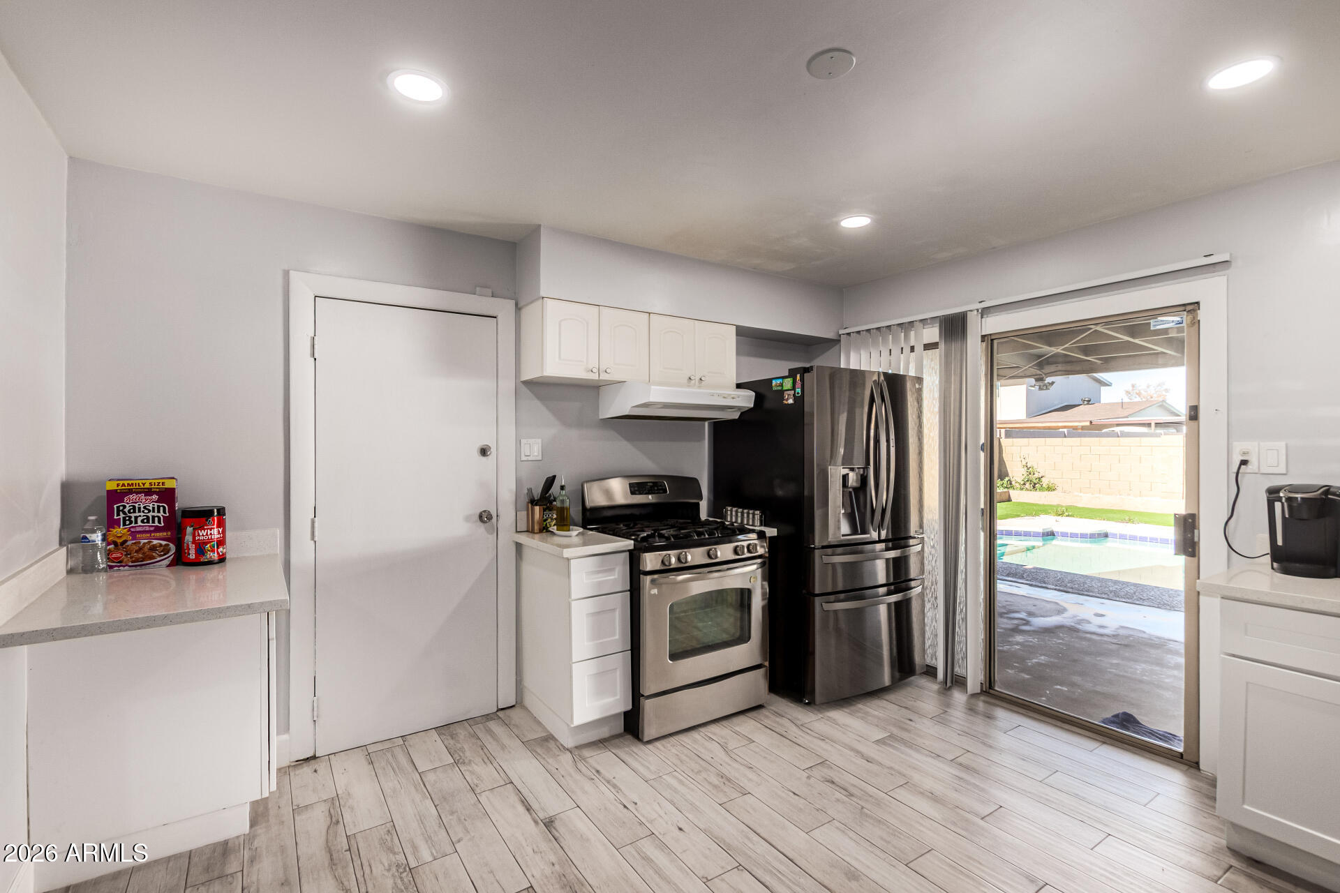 8218 West Osborn Road Phoenix, AZ 85033 - Photo 8 of 27 a kitchen with a refrigerator and a stove