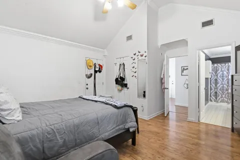 a bedroom with a bed and a chandelier