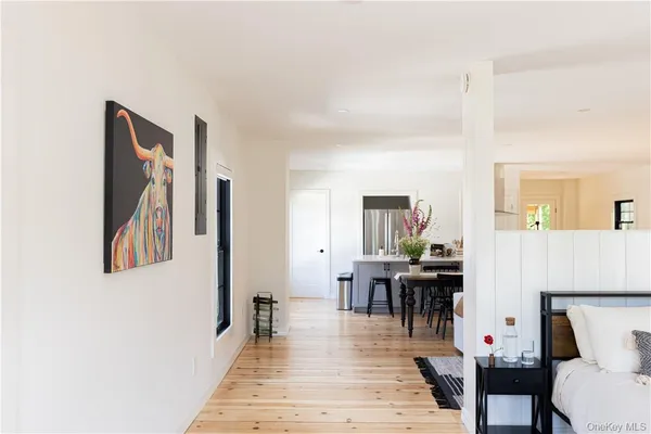 a living room with furniture a wooden floor and dining room