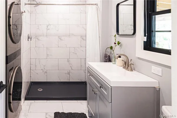 a bathroom with a sink a toilet and a mirror