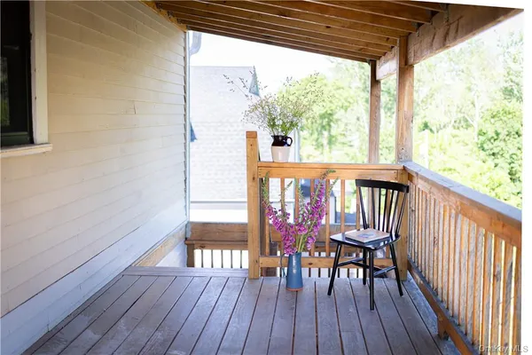 a view of a wooden chairs on the roof deck