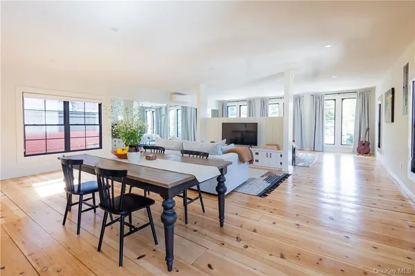 a view of a dining room with furniture and wooden floor