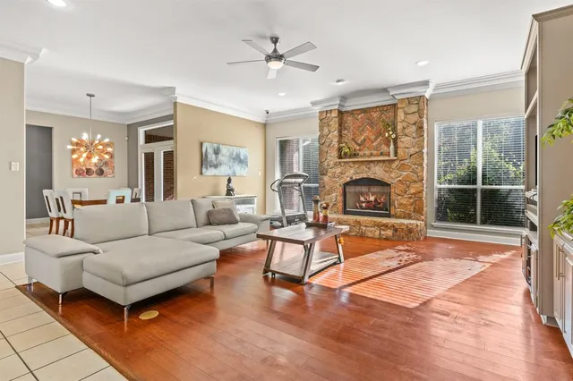 a living room with furniture a fireplace and a chandelier