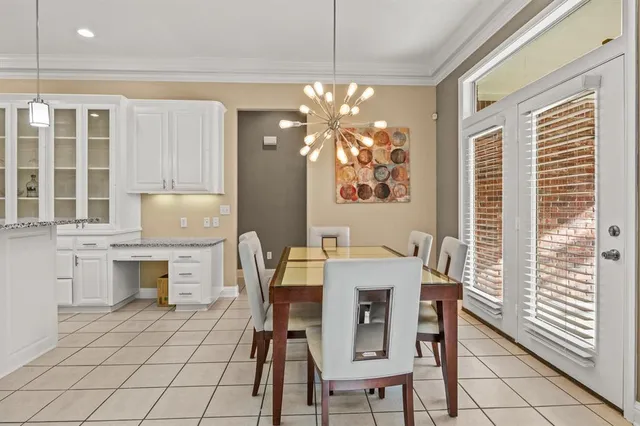 a view of a dining room with furniture and chandelier
