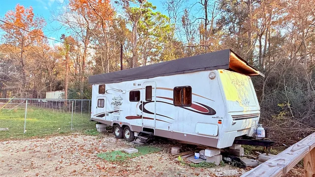 a backyard of a house with barbeque oven