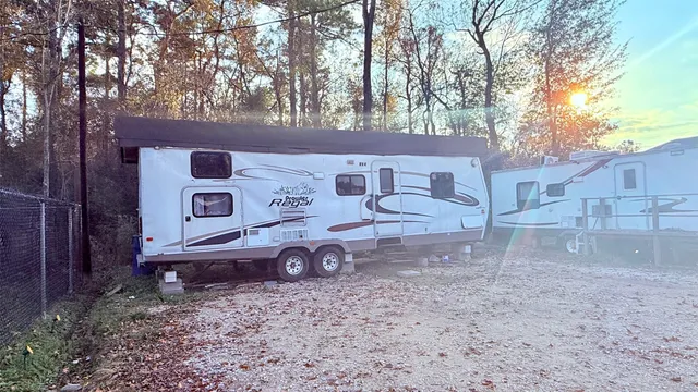 a view of a house with a yard and large tree