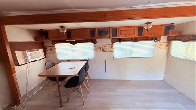 a view of kitchen with stainless steel appliances granite countertop a refrigerator and a stove