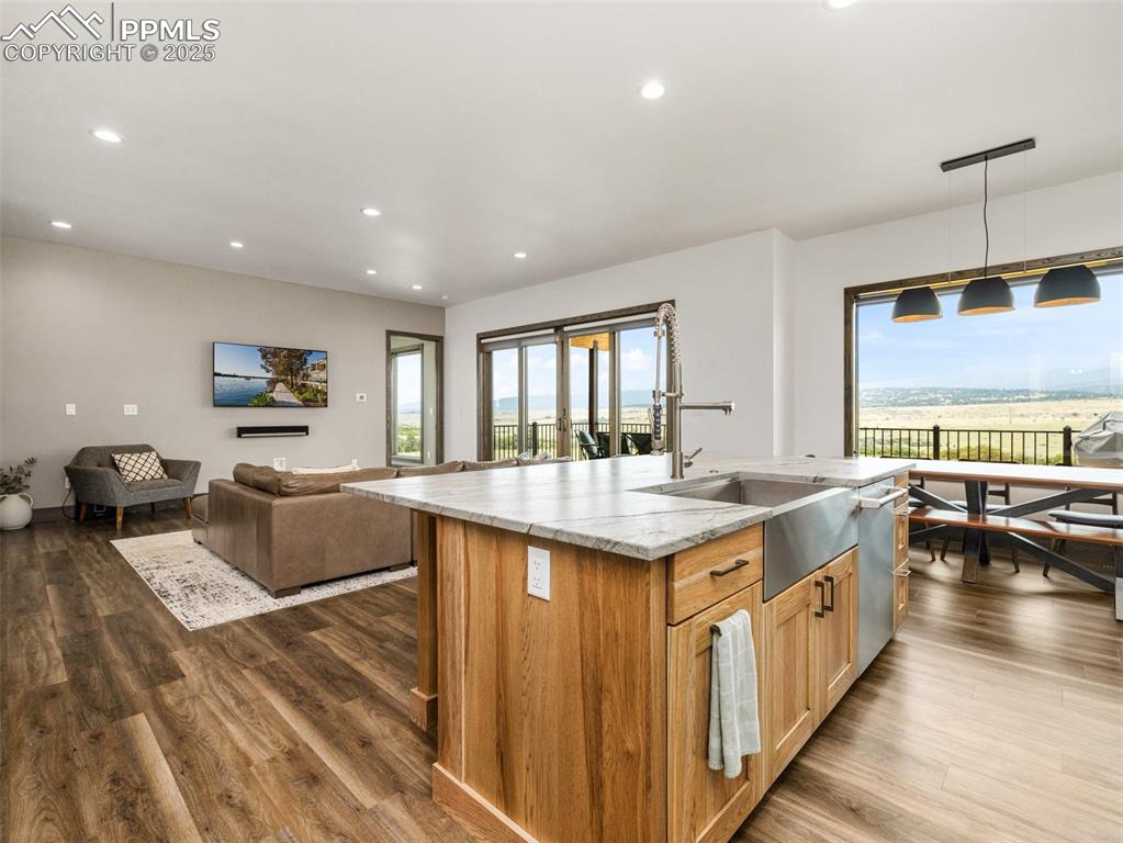 5843 Hart Ranch Drive Beulah, CO 81023 - Photo 15 of 50 a large kitchen with stainless steel appliances granite countertop a lot of counter space and wooden floor