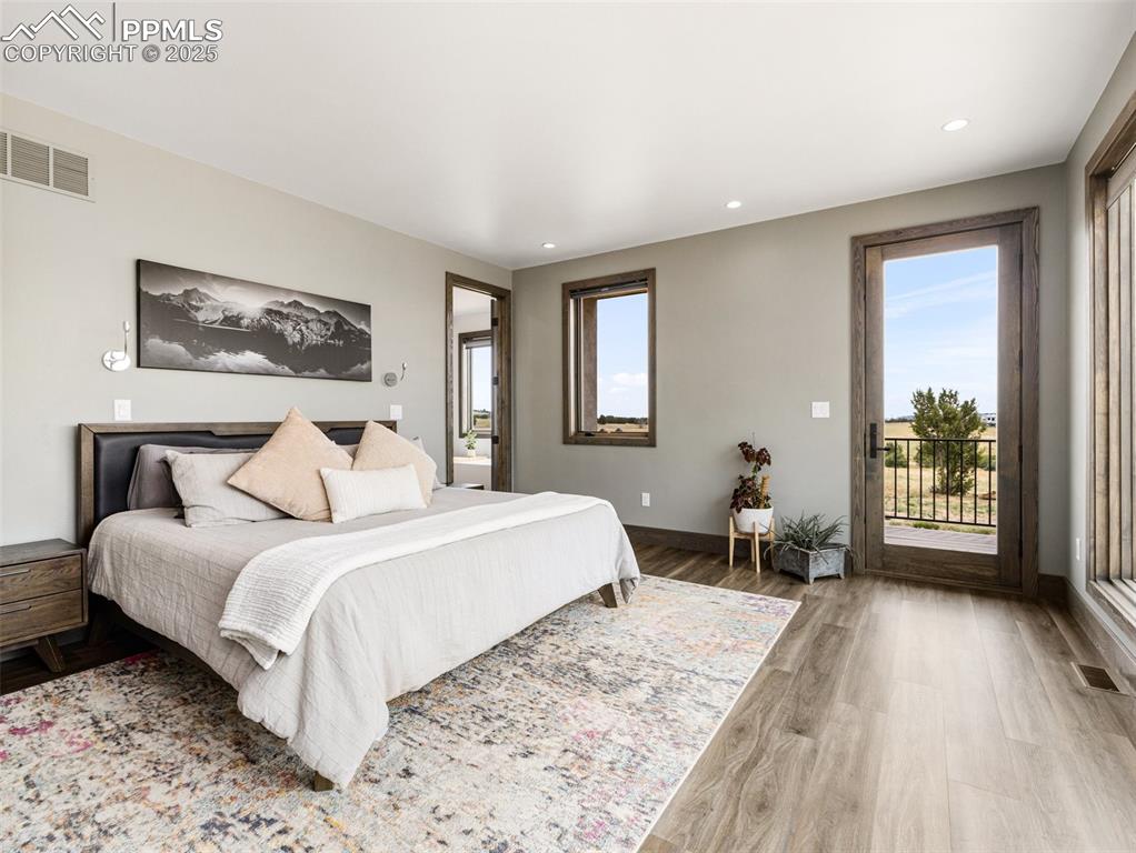 5843 Hart Ranch Drive Beulah, CO 81023 - Photo 16 of 50 a bedroom with a bed couch and a large window