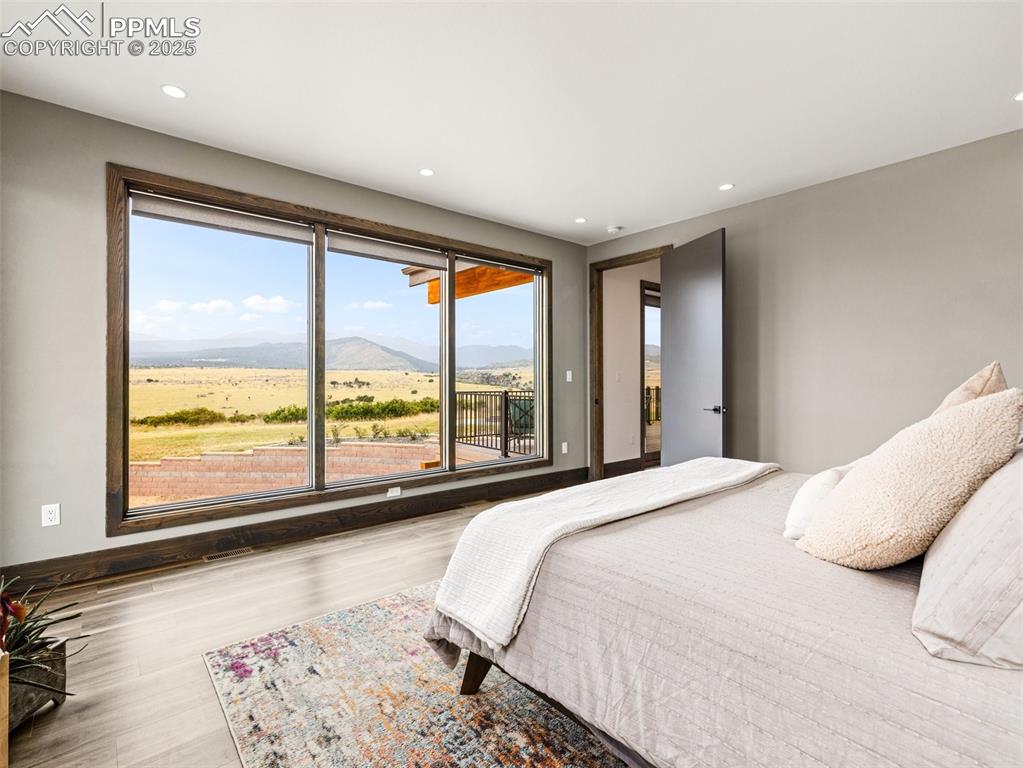 5843 Hart Ranch Drive Beulah, CO 81023 - Photo 18 of 50 a bed sitting in a spacious bedroom next to a window