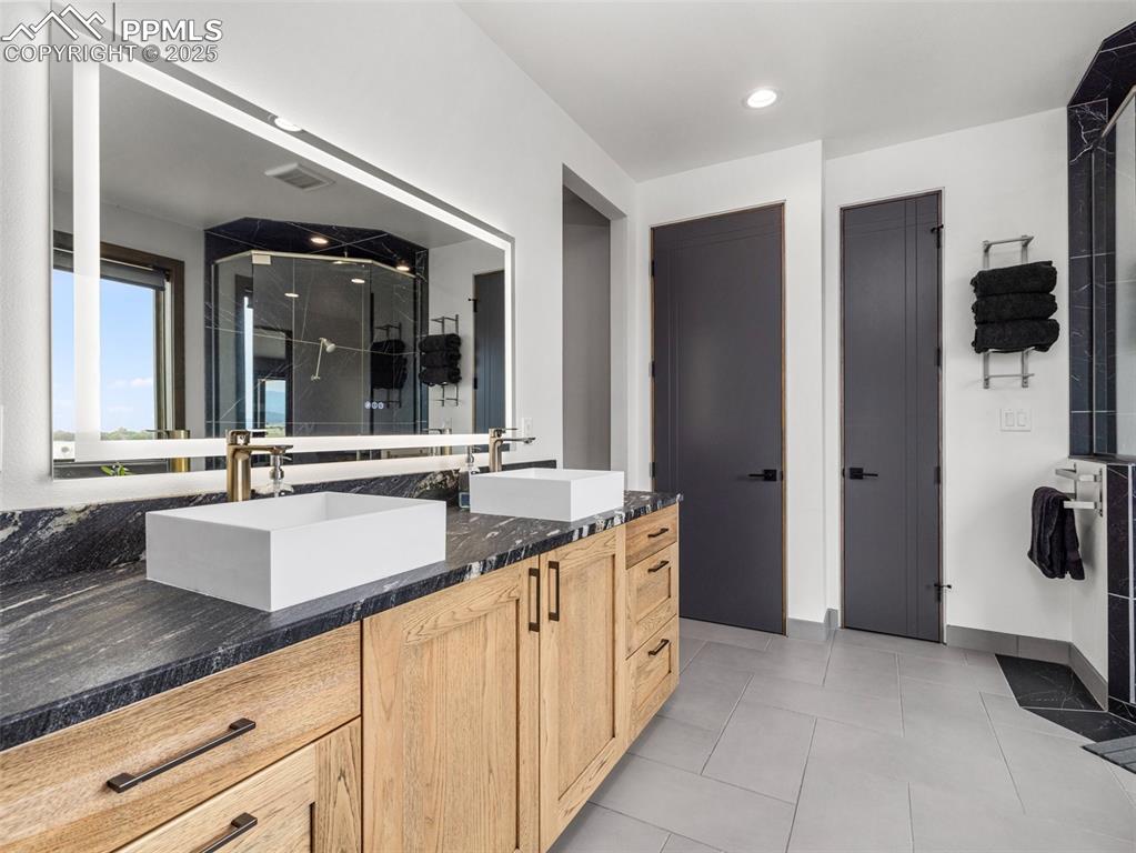 5843 Hart Ranch Drive Beulah, CO 81023 - Photo 19 of 50 a bathroom with a double vanity sink and mirror
