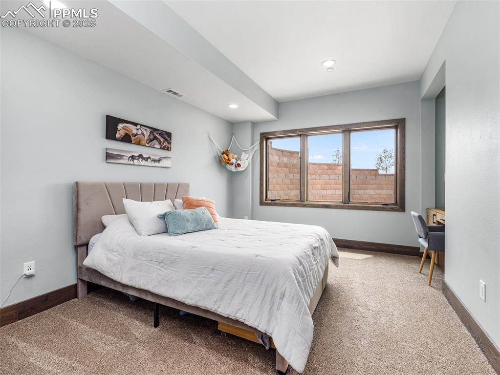 5843 Hart Ranch Drive Beulah, CO 81023 - Photo 32 of 50 a bedroom with a bed and a large window