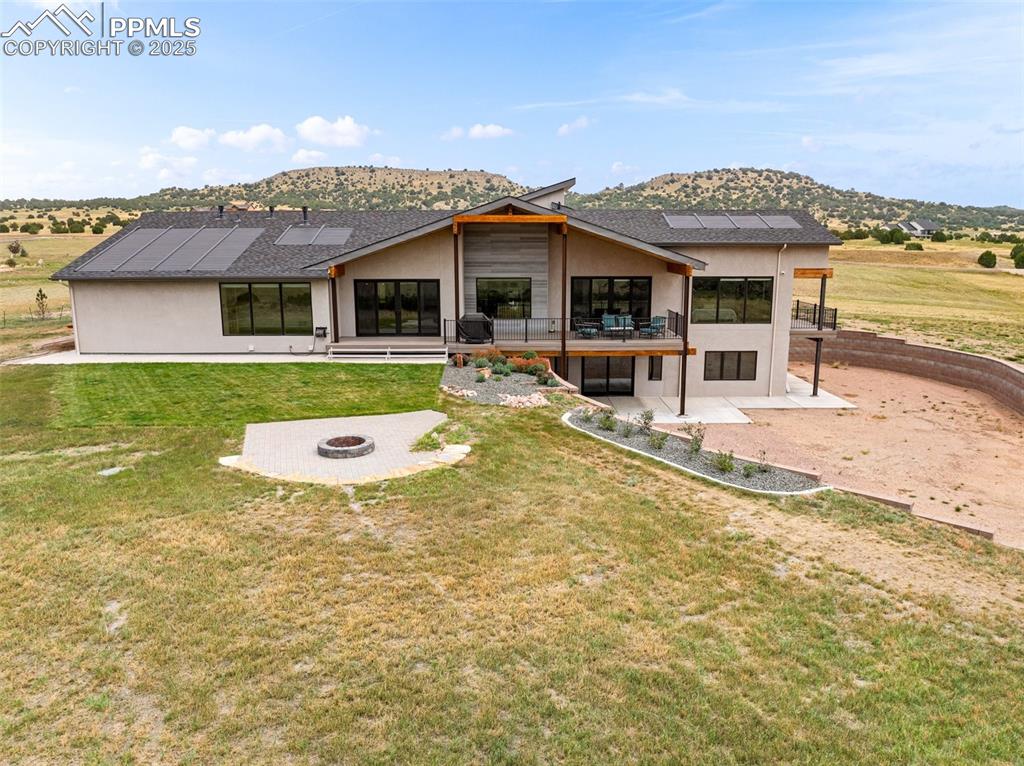 5843 Hart Ranch Drive Beulah, CO 81023 - Photo 35 of 50 a front view of a house with a garden and porch