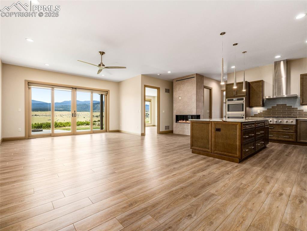 5843 Hart Ranch Drive Beulah, CO 81023 - Photo 37 of 50 a large room with stainless steel appliances kitchen island granite countertop a large cabinets and wooden floor