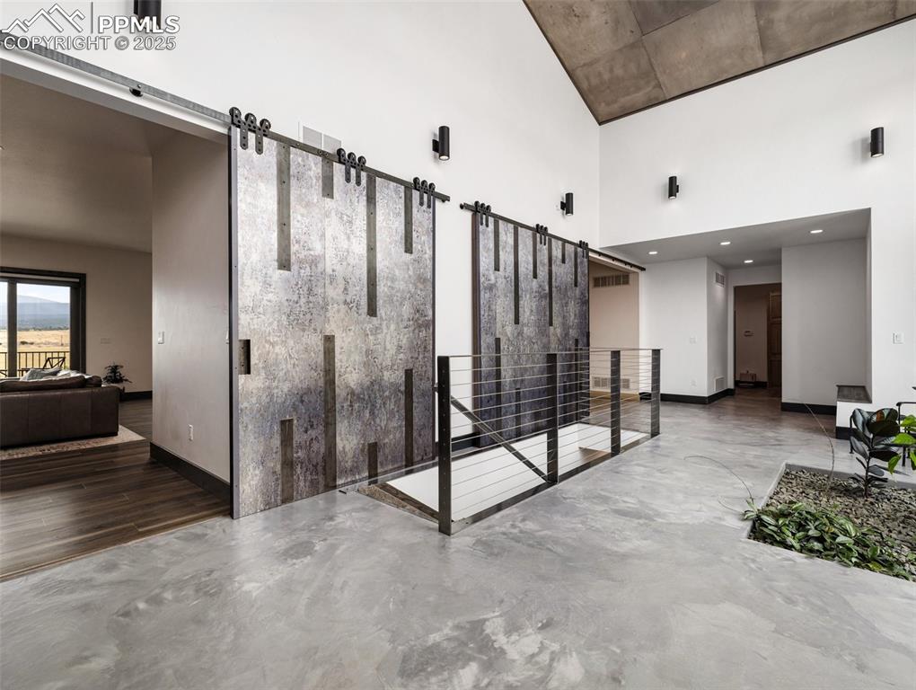 5843 Hart Ranch Drive Beulah, CO 81023 - Photo 4 of 50 a view of a hallway with wooden floor and staircase