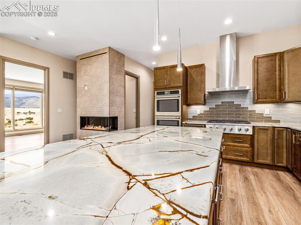 5843 Hart Ranch Drive Beulah, CO 81023 - Photo 43 of 50 a kitchen with kitchen island granite countertop a stove a sink a oven with a dining table and chairs