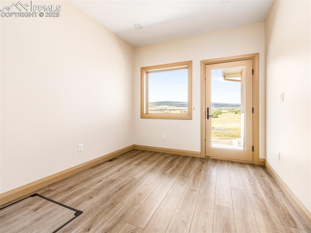 5843 Hart Ranch Drive Beulah, CO 81023 - Photo 44 of 50 an empty room with wooden floor and windows