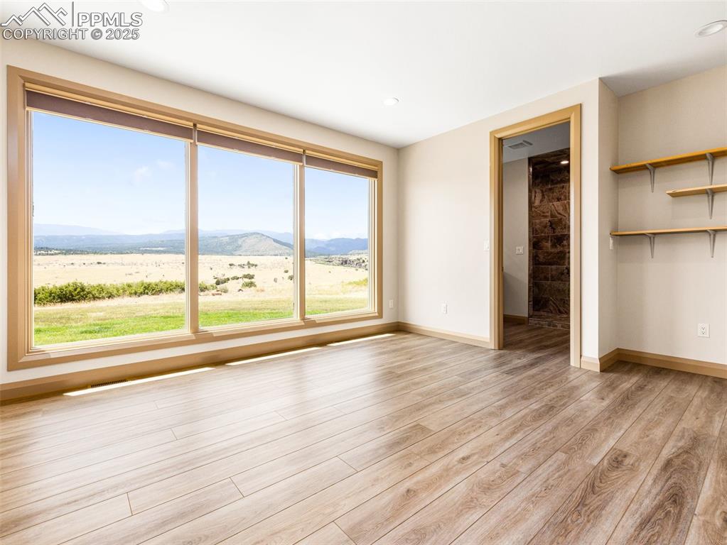 5843 Hart Ranch Drive Beulah, CO 81023 - Photo 46 of 50 a view of an empty room with wooden floor and a window