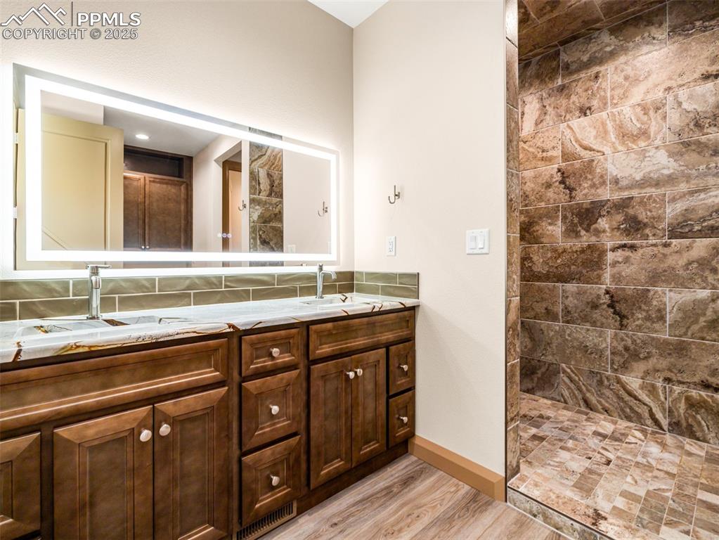 5843 Hart Ranch Drive Beulah, CO 81023 - Photo 47 of 50 a bathroom with a granite countertop sink and a mirror
