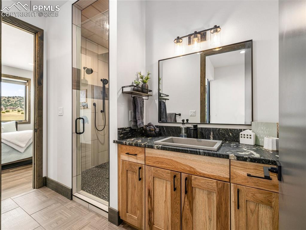 5843 Hart Ranch Drive Beulah, CO 81023 - Photo 6 of 50 a bathroom with a granite countertop sink and a mirror
