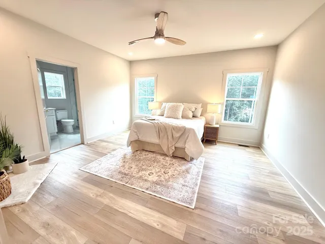 a bedroom with a large bed and a window