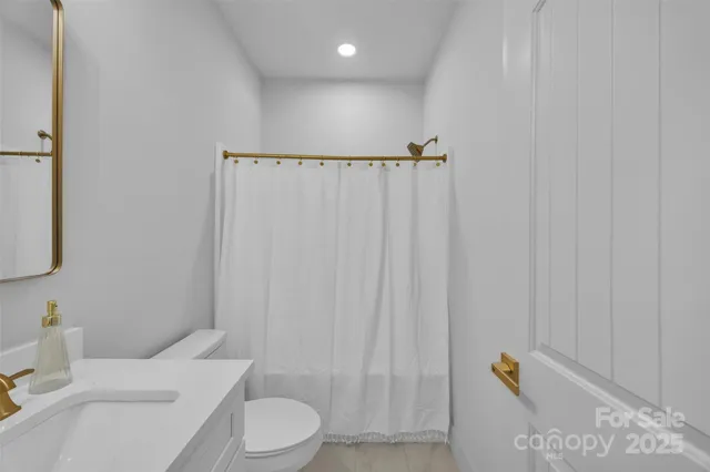 a white toilet sitting next to a bathroom sink
