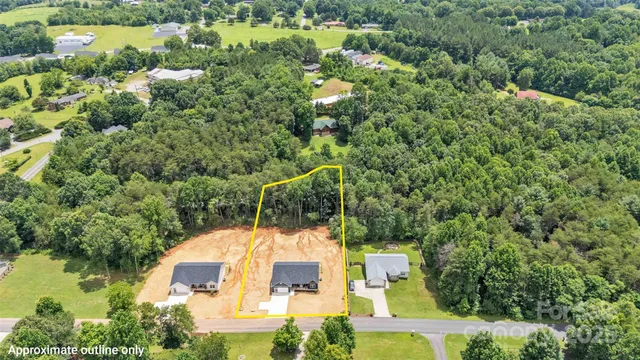 an aerial view of a house with yard swimming pool and outdoor seating