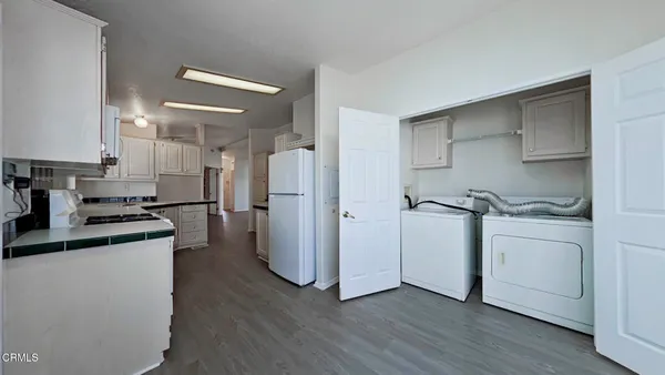 a kitchen with a refrigerator and a stove top oven