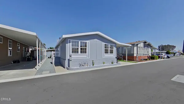 a front view of a house with a street